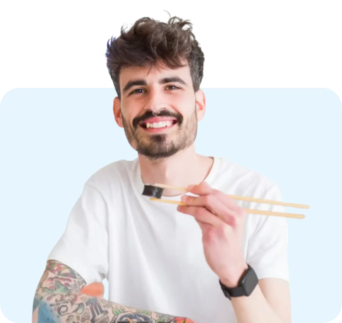 Healthy Young Man Eating Sushi